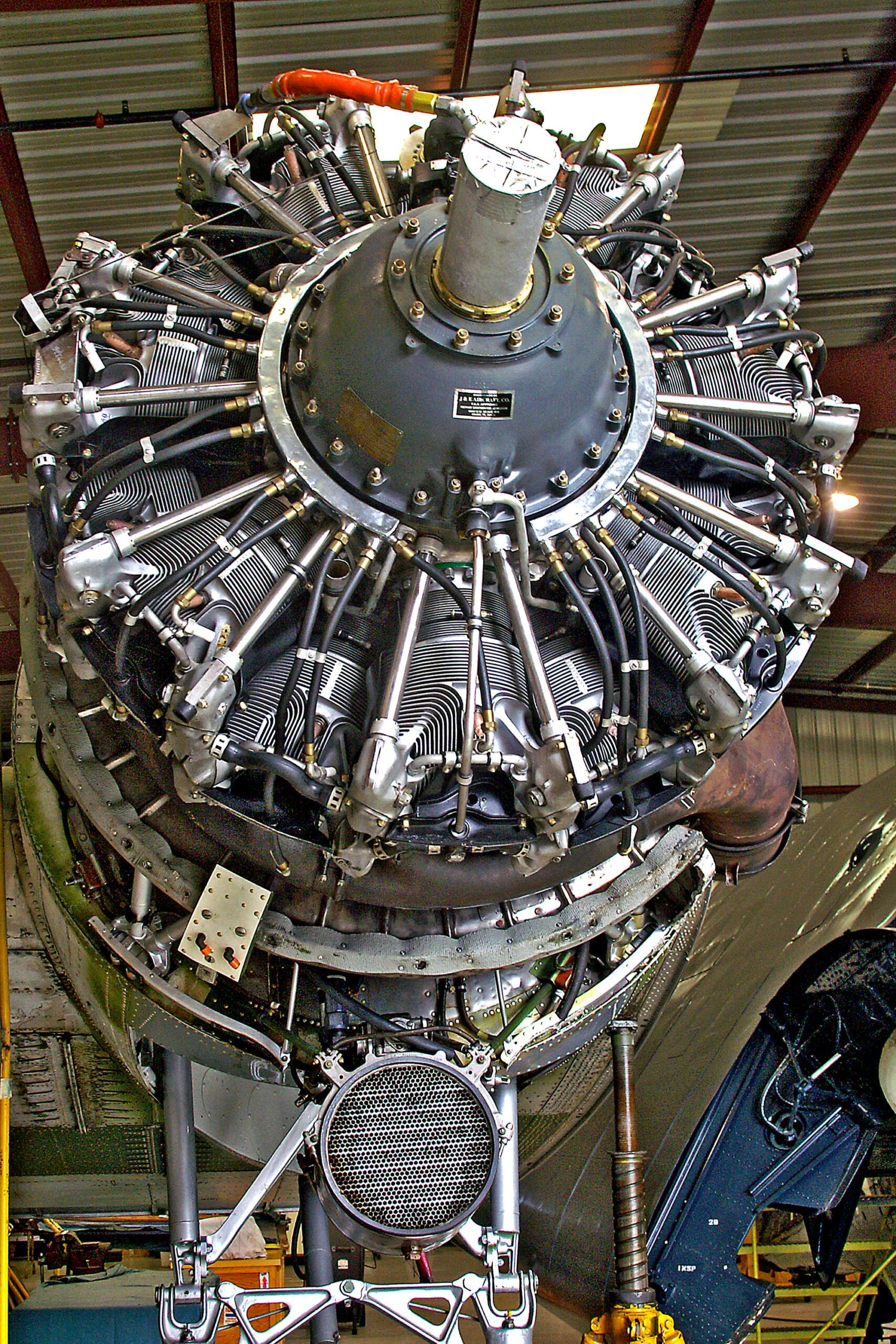 Close-up of a radial aircraft engine in the hangar, showcasing its intricate design and engineering.